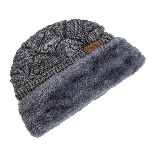 Gray knit beanie with fur trim on a white background